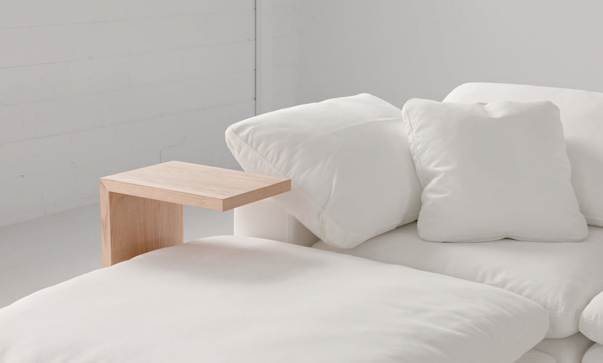 Cloud Range side table top in American oak beside a Cloud Classic sofa