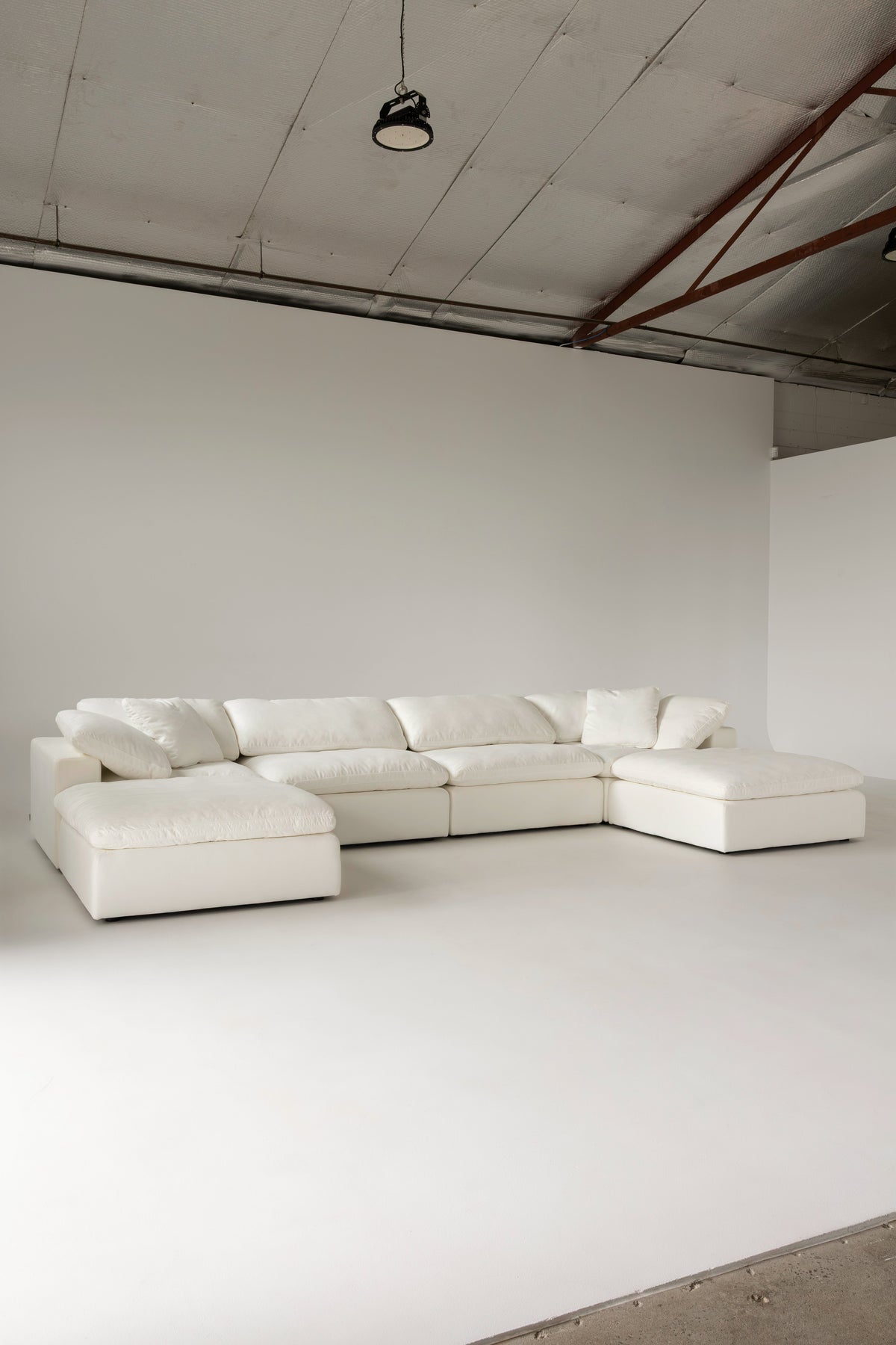 Cloud Classic 6-piece modular sofa with two ottomans in a studio space